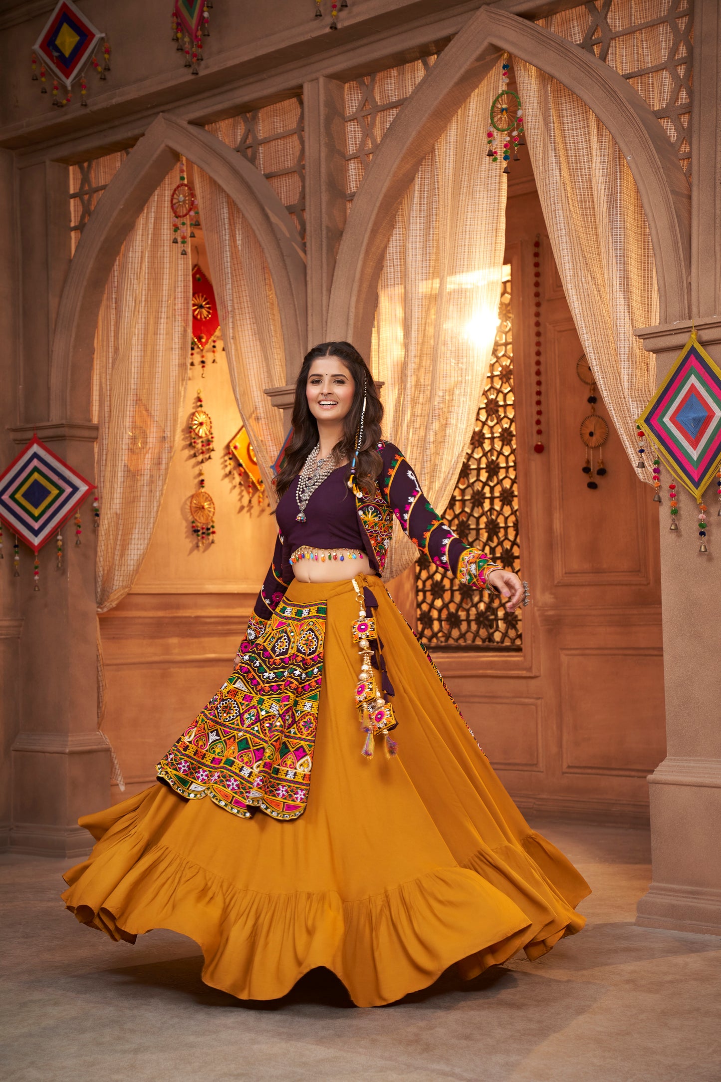 Yellow and Purple Kutchi Chaniya Choli features intricate embroidery and mirror work