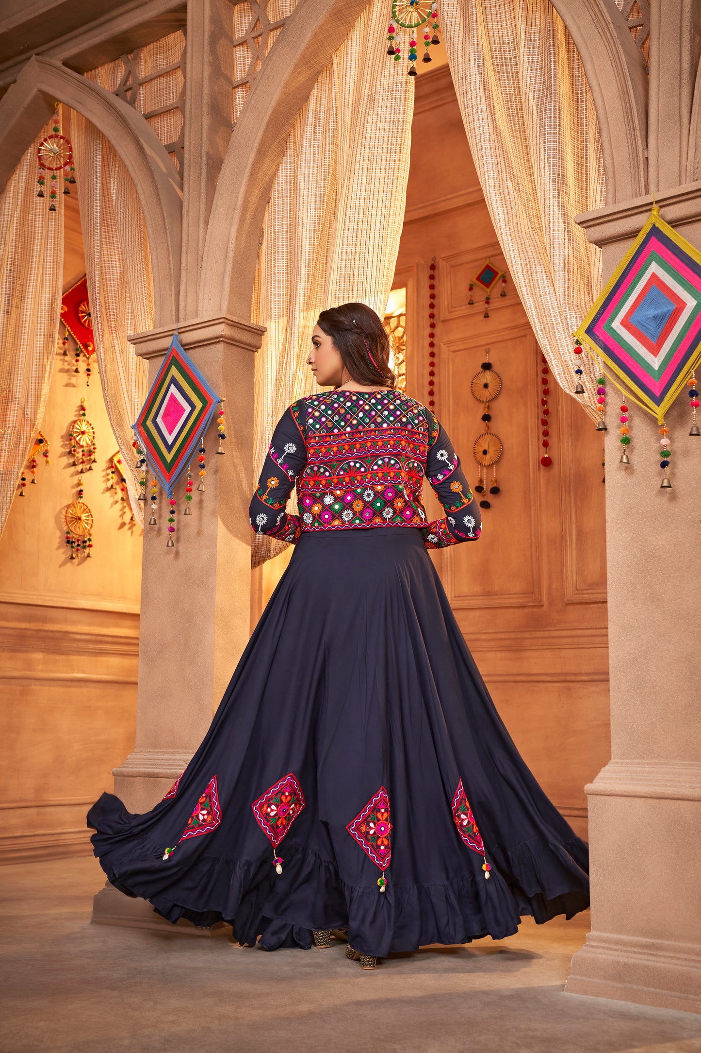 Navy Blue Kutchi Chaniya Choli features intricate embroidery and mirror work.